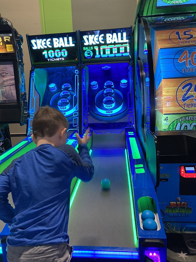 kids enjoying skeeball at the fun lab