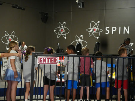kids on a field trip at the fun lab waiting on bumper cars