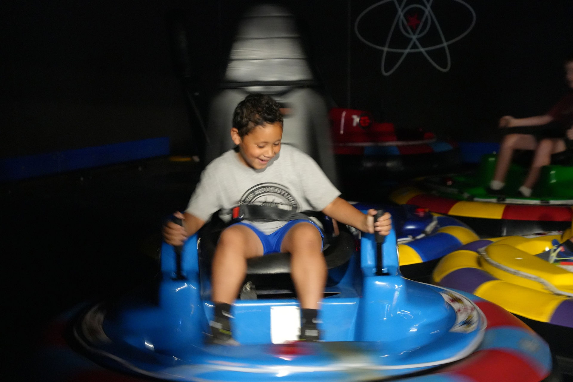 kids playing indoor bumper cars at the fun lab