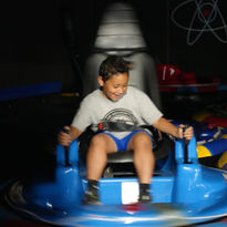 Young child enjoying a bumper car ride at The Fun Lab in Blaine, MN