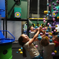 Kids playing in the interactive ball blaster zone at The Fun Lab in Blaine, MN