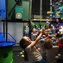 Children playing in a soft foam ball blaster zone at The Fun Lab Blaine, MN.