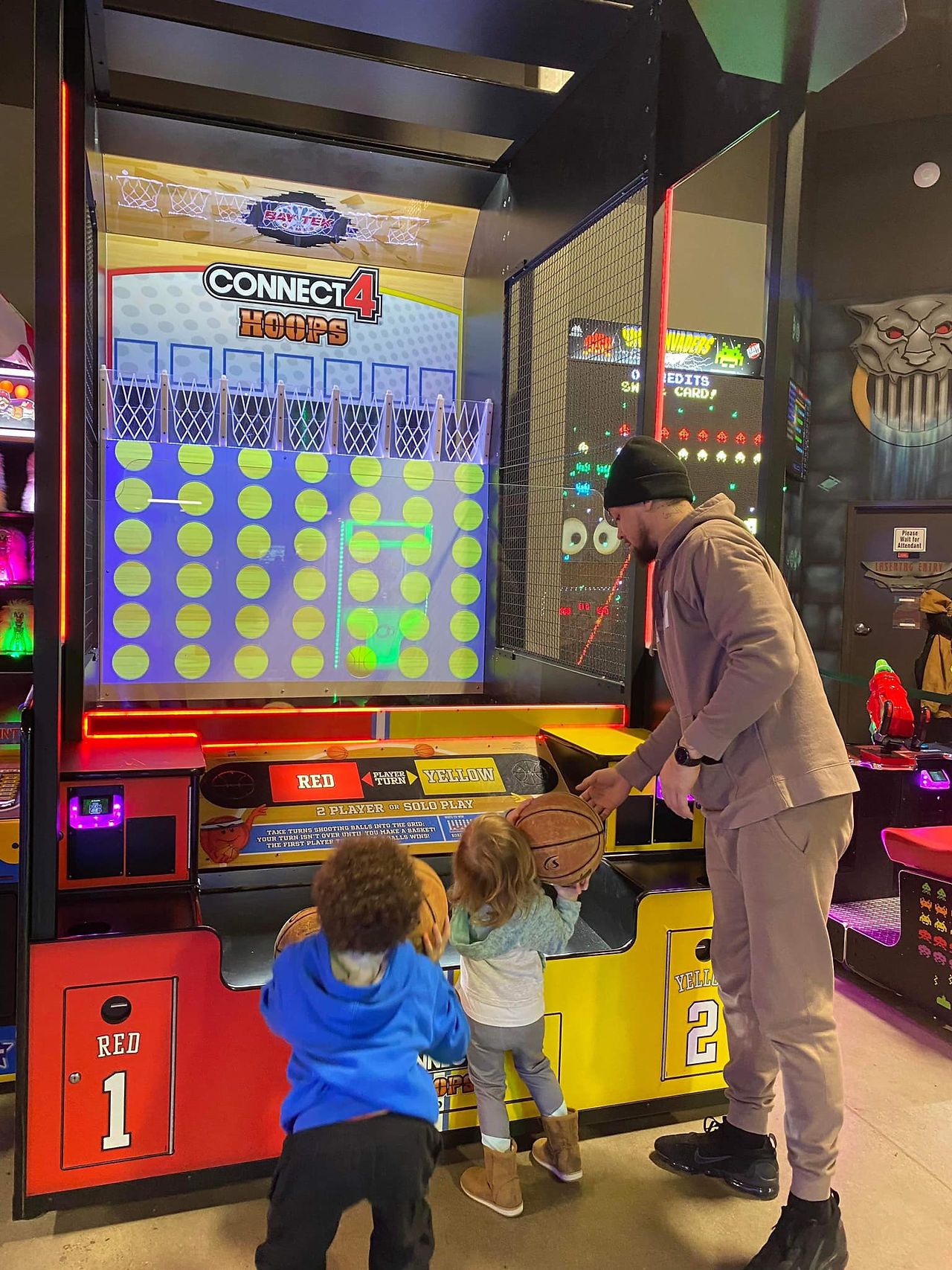 kids and parent playing arcade games at the fun lab