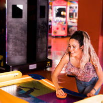 Woman playing air hockey at The Fun Lab