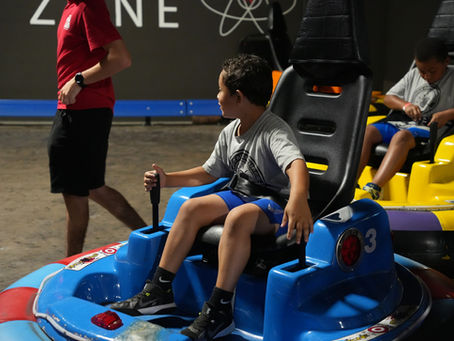 kids playing indoor bumper cars at the fun lab
