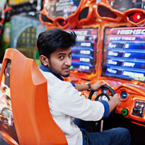 Guest racing in an arcade driving simulator at The Fun Lab in Blaine, MN