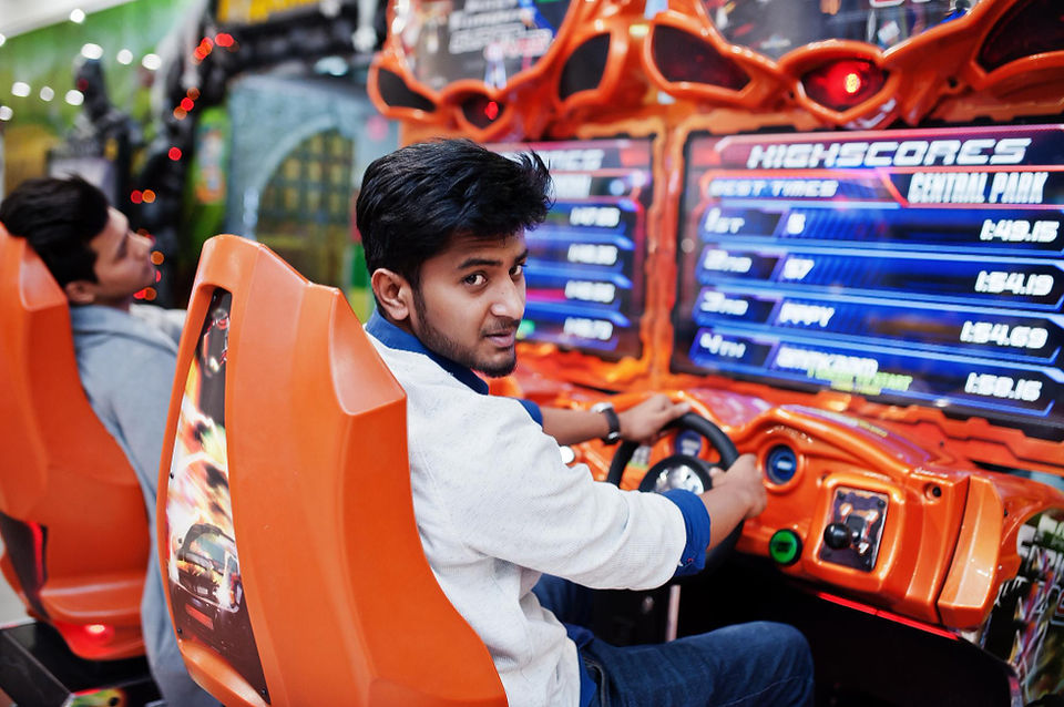 man playing driving arcade game