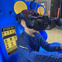 Young boy playing an immersive VR game at The Fun Lab in Blaine, MN.