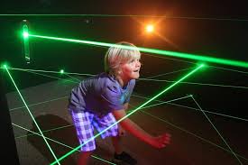 little boy playing laser maze at the fun lab